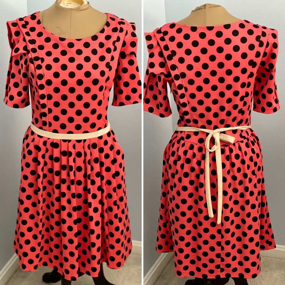 Flared party dress with structured shoulders and pockets